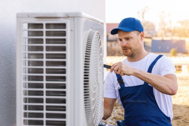 HVAC technician servicing an outdoor air conditioner in Pico Rivera